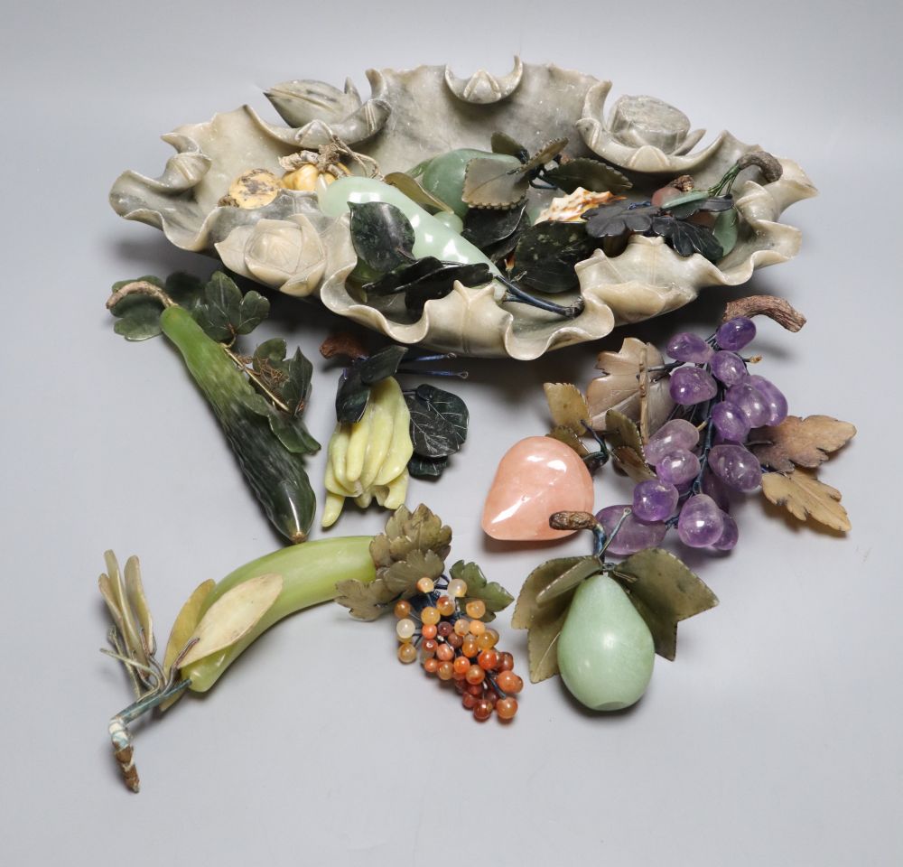 A Chinese soapstone lotus dish containing hardstone models of fruit and a hardstone model of flowers
